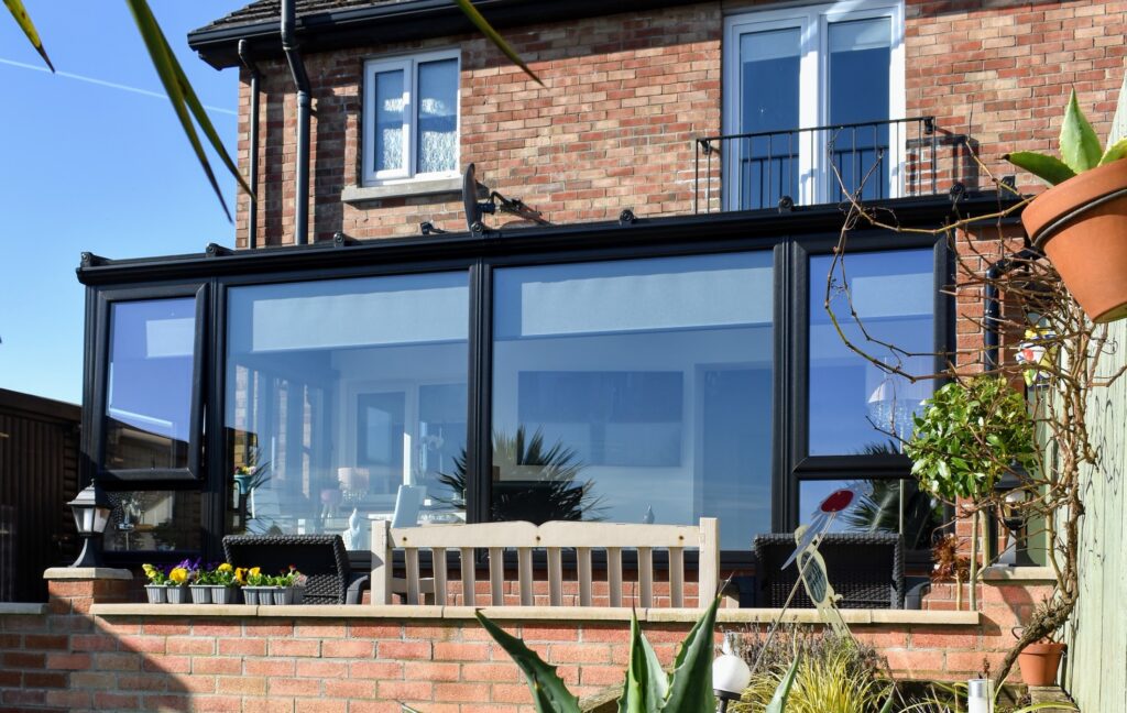 Large Black Lean To Conservatory With Sliding Doors Built By Budget Designer HomeWorks in Belfast