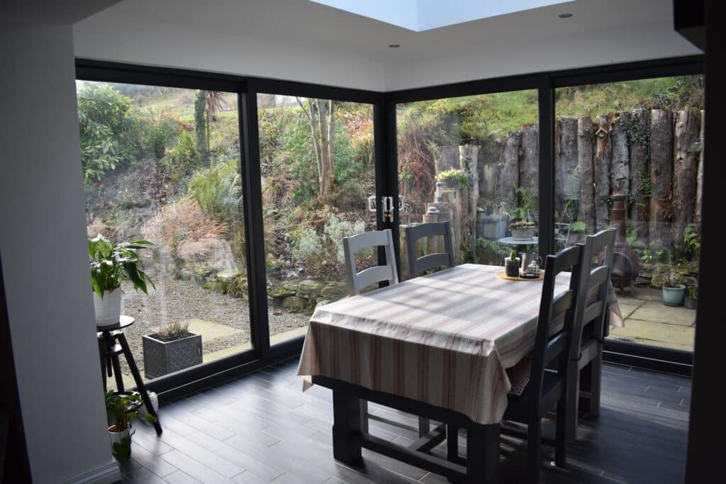 Steel structured pod extension with panoramic garden views by Budget Designer HomeWorks in Northern Ireland