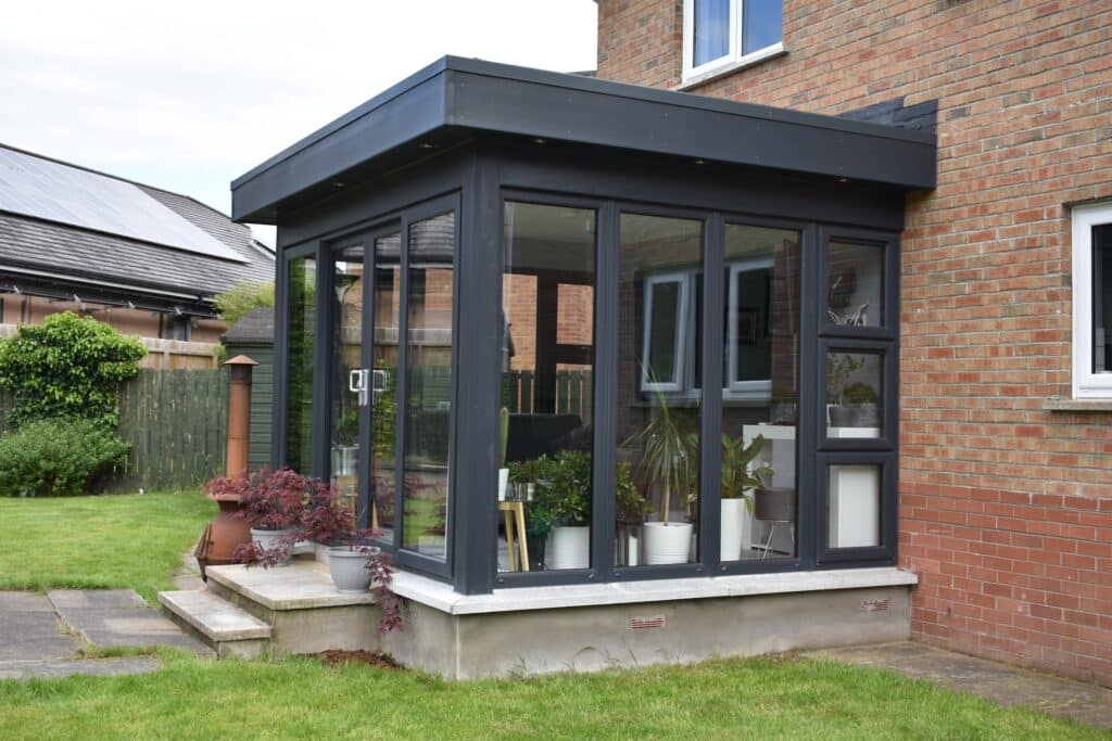 Bright and modern pod sunroom extension connecting home and garden by Budget Designer HomeWorks in Bangor NI