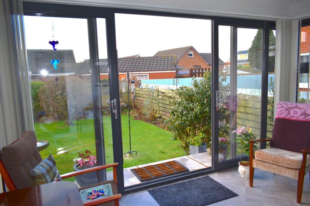 Stylish pod extension with open plan living area and sliding patio doors by Budget Designer HomeWorks in Bangor NI