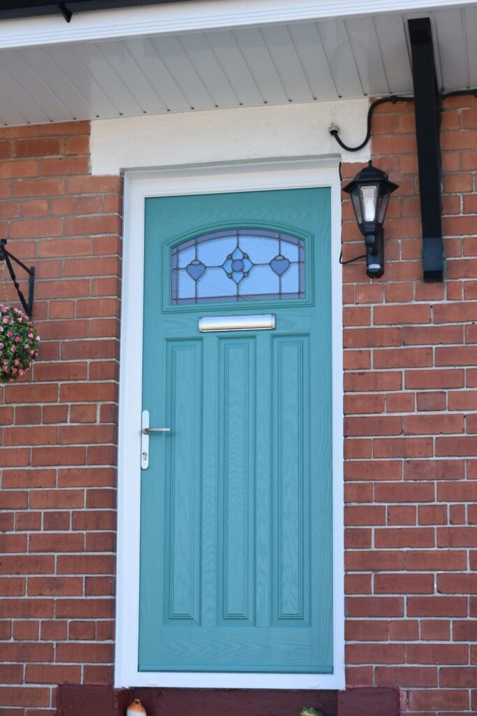 Turquoise composite door with stained glass designed and installed in Belfast by Budget Designer HomeWorks