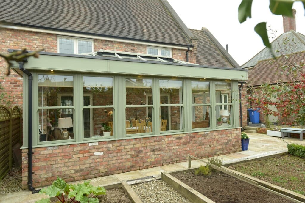 Chartwell green sliding sash windows installed in a large orangery extension in Belfast by Budget Designer HomeWorks